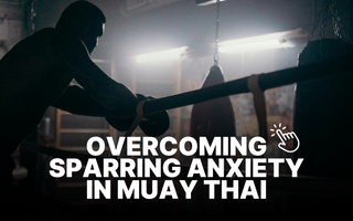 Man in dimly lit Muay Thai gym, resting on the ropes after sparring. 