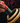 Hand holding black and red boxing glove deodoriser