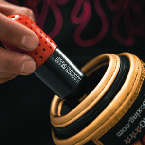 Hand holding black and red boxing glove deodoriser