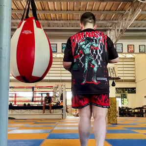 Back of man wearing NAK SUU T-Shirt in a gym in Thailand